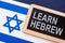 Israel flag and written words Learn Hebrew.
