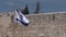 Israel national flag against the Western Wall