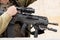 Israeli assault rifle or machine gun in soldier& x27;s hands