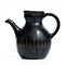 Israeli black ceramic jug in retro style on white