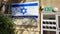 Israeli flag unfurled on the window of a residential building above a clothesline in Israel