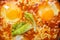 Israeli fried eggs shakshuka with cheese and sauce close-up