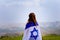 Israeli jewish little girl with Israel flag back view.