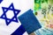 Israeli passport Teudat Zehut on the flag of Israel and Israeli shekel. Israeli citizen, economy in Israel, business in Israel