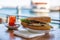 Istanbul fish sandwich. Burger with fried fish. Turkish tea with Balik Ekmek. Blurred background with sea view