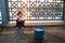 Istanbul, June 15, 2017: Cute little girl sitting in front of a bucket of fish on the Galata bridge.