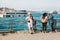 Istanbul, June 15, 2017: Elderly photographer and two young people on the pier. Turkey. In the background is the