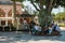 Istanbul, June 15, 2017: Group of people resting on a bench around beautiful tree and vendor is working at Kamaras