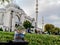 The Istanbul snow globe stands on a green lawn against a blurred background of the Suleymaniye Mosque Turkey. Tourist souvenir