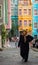 Istanbul, Turkey. 10-November-2018. A syrian refugee woman in Fener-Balat with colorful houses behind