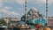 Istanbul, Turkey - June 11, 2019: View of the beautiful white mosque on Eminenu pier. Nearby moored ship Chinese style