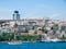 Istanbul / Turkey Touristic  cruise ship with passengers at Bosporus strait. Residential buildings at coast in the background