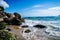 Itaguacu Beach in San Francisco do Sul in Santa Catarina Brazil, with a rough sea hitting the water on the rocks