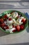 Itaian vegetarian food, fresh caprese salad made with white soft italian mozzarella cheese, red tomato and green basil