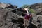 Italian alps - june 2020: a climber clinging to a spur of rock looks beneath her