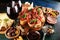 Italian antipasti wine snacks set. Cheese variety, Mediterranean olives, seafood salad, Prosciutto di Parma, tomatoes, anchovy and