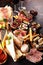 Italian antipasti wine snacks set. Cheese variety, Mediterranean olives, seafood salad, Prosciutto di Parma, tomatoes, anchovy and