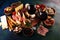 Italian antipasti wine snacks set. Cheese variety, Mediterranean olives, seafood salad, Prosciutto di Parma, tomatoes, anchovy and