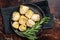 Italian appetizer Artichoke hearts pickled in olive oil with herbs and spices Dark background. Top view