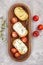 Italian appetizer toasted bread bruschetta with cream chease and tomatoes