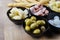 Italian appetizers with green olives, spring onions, porchetta ham, fontina cheese, smoked provola cheese and breadsticks