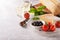 Italian appetizers, view from above - bread ciabatta, olives, tomatoes, cheese, pepper, fresh basil and wine