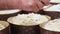 Italian baker sprinkling candy on top preparing panettone christmas cake before baking