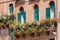 Italian balcony with flowerpots and flowers