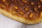 Italian bread with cheese, tomatoes and herbs. Focaccia on the table