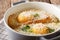 Italian bread Pawese soup close-up in a saucepan. horizontal