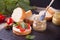 Italian bruschetta with cream cheese, tomato cherry and bazil and cutting bread on the plate with small bottle of mustard