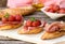 Italian bruschettas with ham prosciutto, coppa, salami, cherry t