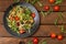 Italian bucatini with shrimp, arugula and cherry tomatoes. Wooden background. Close-up. Top view