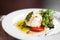 Italian burrata cheese with tomatoes, herbs, pesto and olive oil