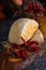 Italian caciotta cheese with hot chili pepper on rustic wooden cutting board