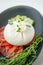 Italian cheese burrata, tomatoes and vegetables close-up. A layer of mozzarella with creamy straticella inside