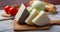 Italian cheeses, mature Tuscan Pecorino sheep cheese and Provolone dolce cow cheese served with olive bread and tomatoes