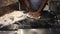 Italian chef preparing pizza with sauce at a restaurant