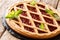 Italian cherry crostata pie decorated with mint closeup. horizon