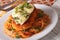 Italian chicken Parmigiana and pasta close up on a plate. Horizontal