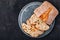 Italian ciabatta bread slices with on stone plate on dark concrete background