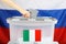Italian citizen resident in Russia casts her ballot paper in a b