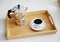 Italian coffee espresso maker moka pot and white cup of coffee on bamboo wooden tray