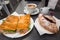 Italian coffee with jam croissant and sandwich on the table