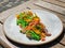 Italian colored noodles with seafood - scallop shrimp and octopus tentacles. Decorated with yellow daisy petals. Beautiful and