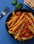 Italian Comfort: Penne Pasta in Tomato Sauce with Chicken and Fresh Tomatoes on a Rustic Wooden Table. AI Generated