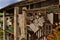 Italian country building with farm tools and furniture hanging on wall