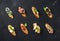 Italian crostini with various toppings on black plywood background