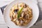 Italian cuisine: Conchiglie with porcini and parmesan closeup. H