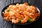 Italian cuisine: pasta with squid, tiger shrimps, vegetables, pa